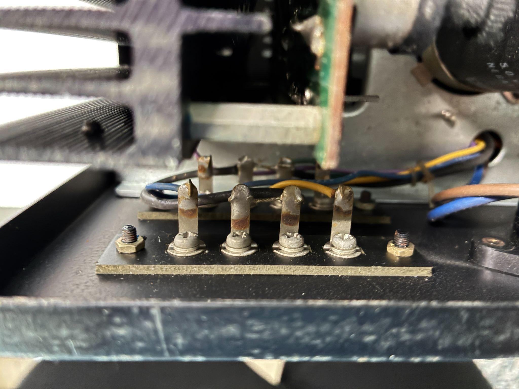 Mounting screws visible after removing the terminal assembly