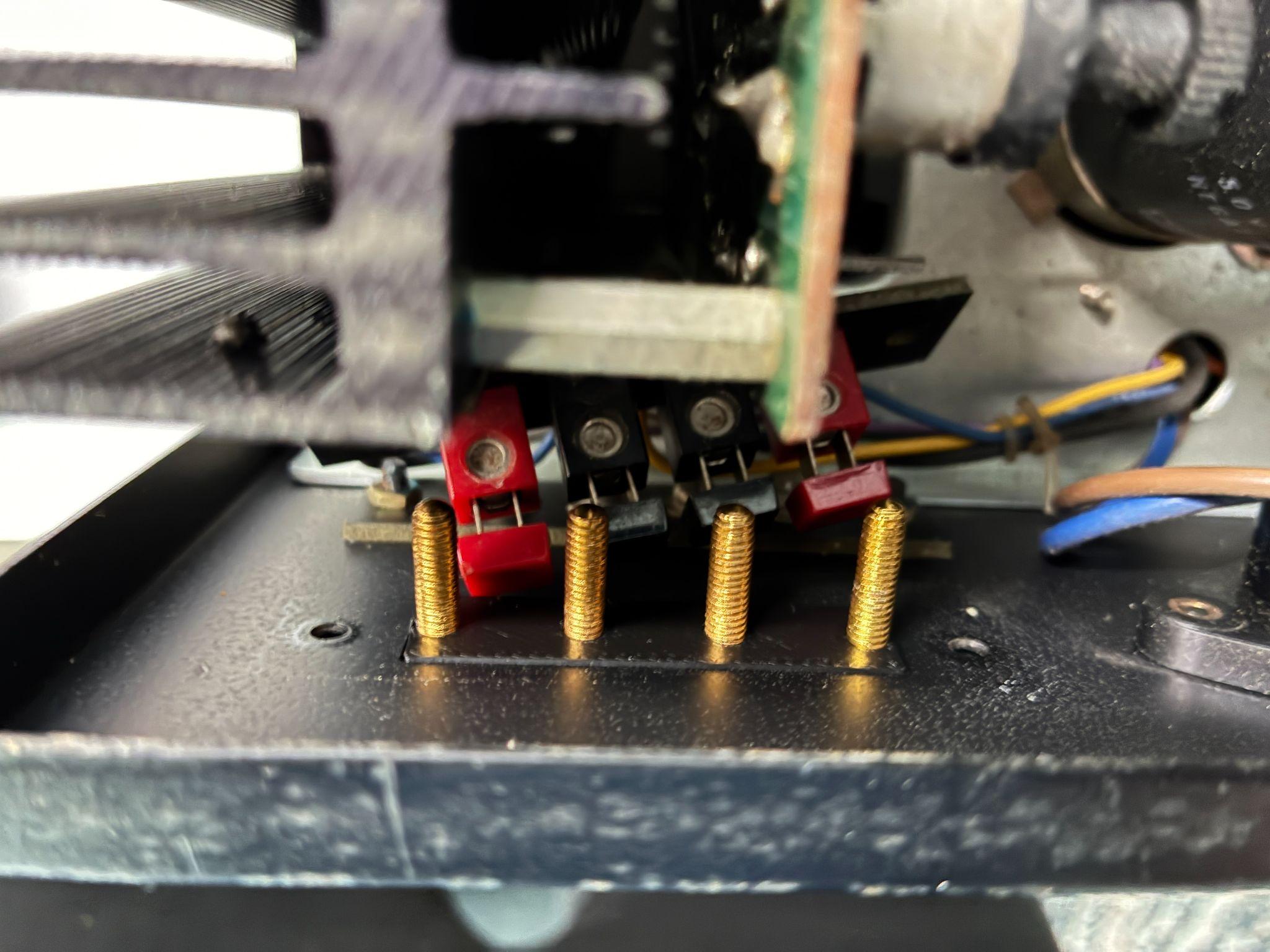 Four binding posts inserted into the front adapter plate — nuts loose